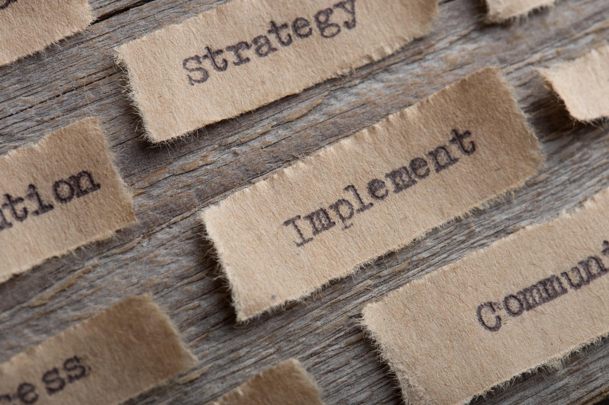 Two small embroidered labels on kraft paper